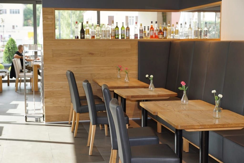 Wood tables and booth seating in a bright bistro