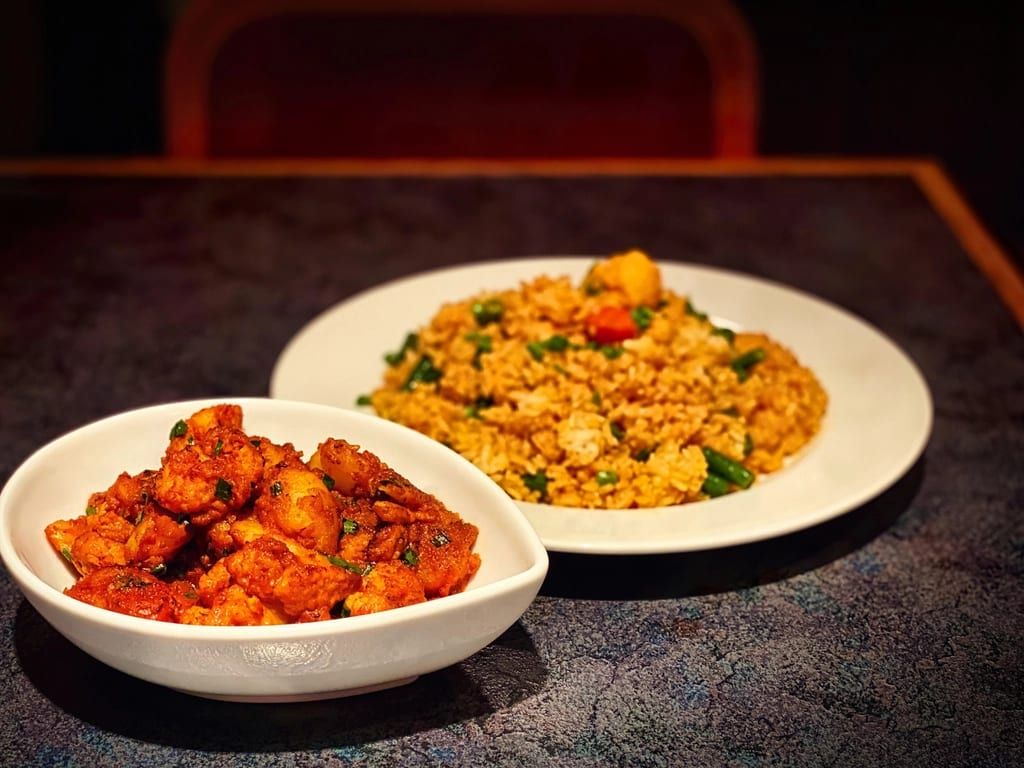 Fried rice beside a bowl of glazed fried chicken
